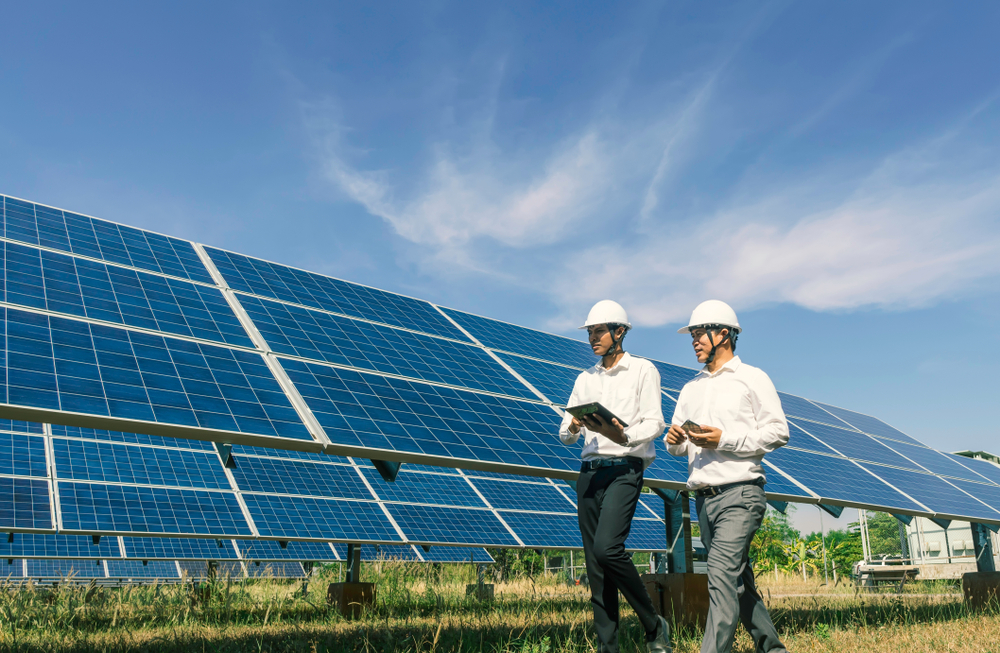 A photo of workers near an industrial solar energy system.